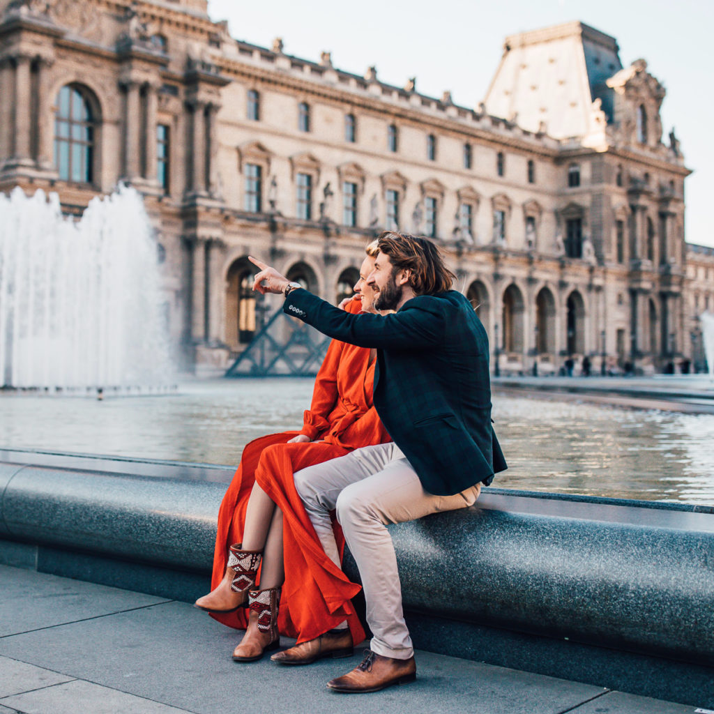 Cute couple in front of a fountain with kilim rug leather boots